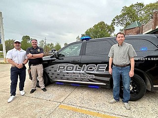Prairie Grove Police Chief Chris Workman (center) shows off the Police Department's new vehicle April 15 prior to the City Council meeting. Council members Chris Powell (left) and Doug Stumbaugh stand with Workman.
(NWA Democrat-Gazette/Lynn Kutter)